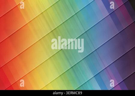 A colorful abstract background featuring a full rainbow spectrum of vertical light rays crossed by sharp, parallel diagonal lines for a dynamic effect Stock Photo