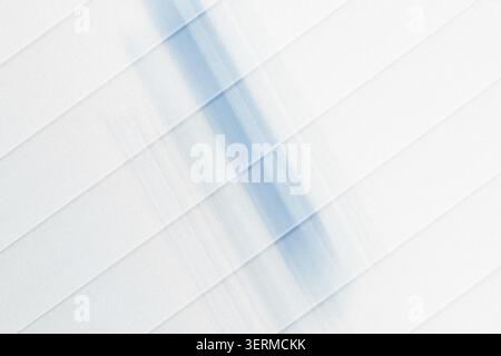 A modern abstract background featuring diagonal stripes and soft, flowing blue light streaks, creating a sense of movement and depth. Stock Photo