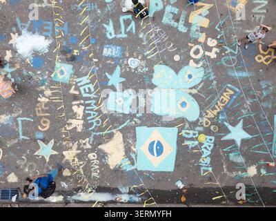 Rio de Janeiro, Brazil - 13 June 2026: Aerial view of street pavement decorated with colorful chalk drawings of the Brazilian flag and stars for the W Stock Photo