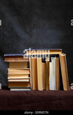A stack of old books and notebooks on the table Stock Photo