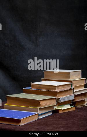 A stack of old books and notebooks on the table Stock Photo