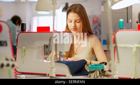 Young woman learning sewing skills in workshop Stock Photo