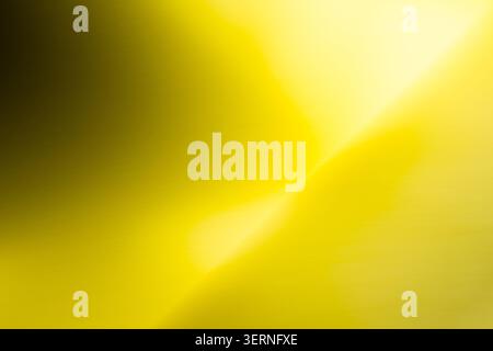 Abstract diagonal gradient featuring intense yellow tones and a dark, shadowed corner with a fine metallic grain. The sharp contrast evokes themes of Stock Photo
