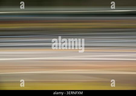 Dynamic horizontal motion blur in grey, tan, and lime green. Sleek streaks suggest speed and energy, creating a sophisticated minimalist background fo Stock Photo