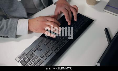 Close up male hands typing computer keyboard top view unrecognizable business man working with internet technology online device chatting businessman Stock Photo