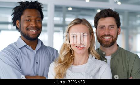 Portrait three diversity business coworkers smiling happy friendly in office team African American businessmen with Caucasian businesswoman smile Stock Photo