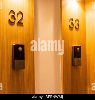 Modern apartment doors with numbers 32 and 33 and electronic intercoms Stock Photo