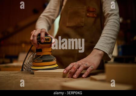 Adult Carpenter Sanding Wood in Workshop for Handmade Product Stock Photo