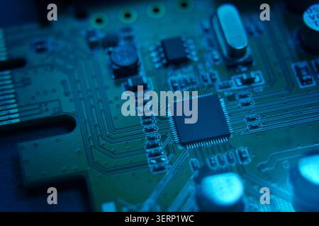 A CloseUp Image of a Circuit Board Emitting a Striking Neon Glow Effect in Detail Stock Photo
