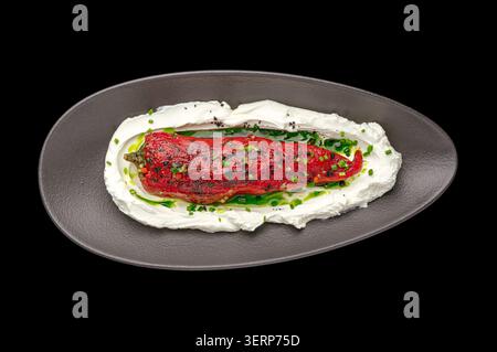 Gourmet roasted red pepper on a creamy yogurt spread Stock Photo