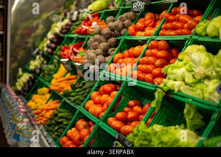 Fresh vegetables and produce on vibrant display at grocery store Stock Photo