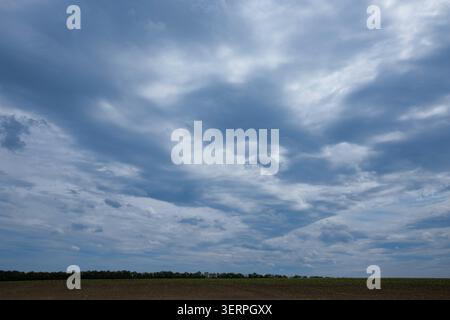 Dark dramatic storm clouds covering the sky before heavy summer thunderstorm arrives Stock Photo