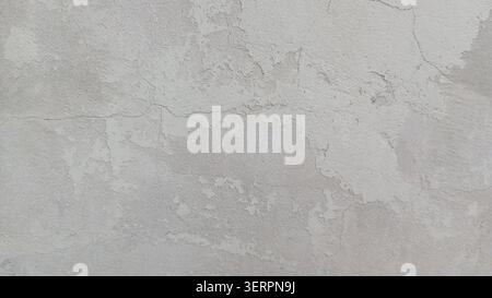 Textured wall surface shows signs of wear from age and exposure, highlighting the natural patterns created over time Stock Photo