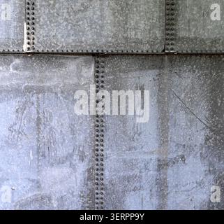 Horizontal close up of a weathered galvanized metal water tank surface with vertical and horizontal seams Stock Photo