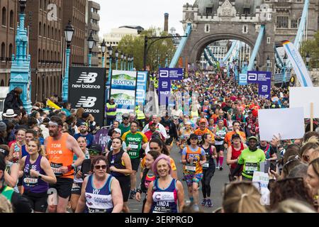 Runners at the London Marathon crossing Tower Bridge. London, UK, 21 April 2024 Stock Photo