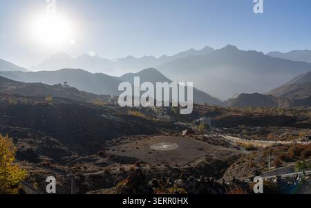 Helipad above Muktinath village at sunset in Mustang with layered Himalayan ridges in the Nepal Himalayas Stock Photo
