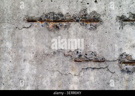Concrete Wall with Exposed Rusted Rebar and Cracks Stock Photo