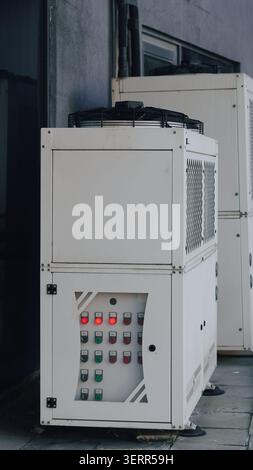 Closeup of outdoor industrial HVAC chiller unit control panel with illuminated indicator lights. Stock Photo