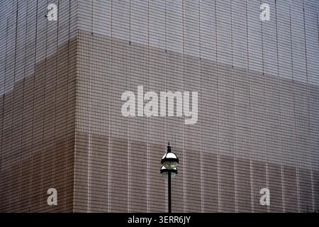 Minimalist Urban Architecture Abstract with Tiled Facade and Classic Street Lamp Stock Photo