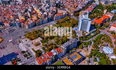 Aerial drone view of Taksim Square and Gezi Park in Beyoğlu district with autumn foliage and Turkish flags, Istanbul, Turkey Stock Photo