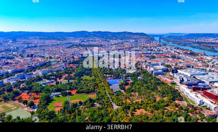 Aerial drone view of Vienna with Prater park Hauptallee, WU Vienna campus, sports facilities and Danube River, Austria Stock Photo