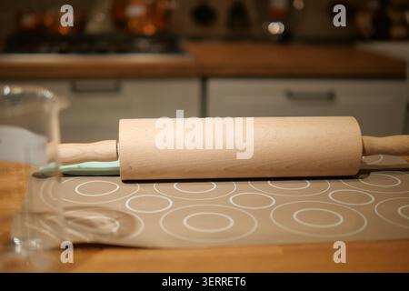 Rolling pin on table in kitchen during cooking time Stock Photo