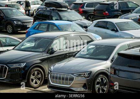 A high angle view of multiple modern passenger vehicles and sport utility vehicles packed closely together in rows at an outdoor city parking lot Stock Photo