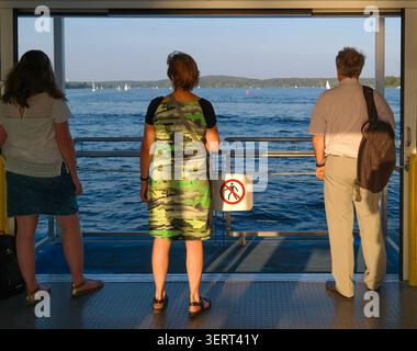 Passengers aboard BVG ferry F10 Kladow–Wannsee crossing Lake Wannsee, Berlin-Spandau to Steglitz-Zehlendorf, Germany. Stock Photo