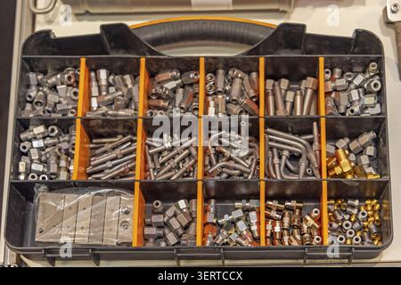 Smal Metal Parts Nozzles Valves Nuts and Bolts Hardware Fittings Organizer Box Top View Stock Photo