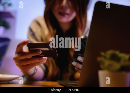 Close up hand of person making cashless payment credit card online transaction mobile phone commerce smart technology digital banking electronic walle Stock Photo
