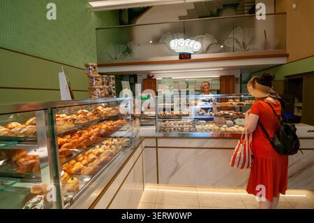 A tourist and shopper at the Poppella pastry shop on Via Santa Brigida in Naples. Italy Stock Photo