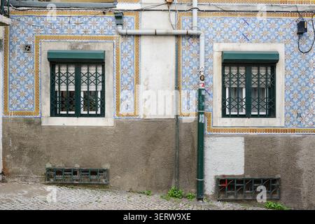 Symmetrical Windows on Traditional Azulejo Facade in Lisbon, Portugal. Stock Photo