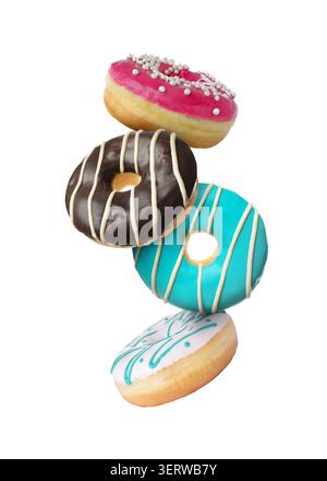Sweet donuts covered with icing falling on white background Stock Photo