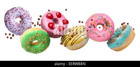 Sweet donuts and sprinkles falling on white background Stock Photo