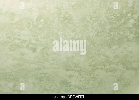Overhead flat lay shot of a blank green decorative printed background. The solid textured surface features a subtle graphic or matte finish, creating Stock Photo
