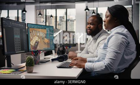 Team of designers developing digital 3D architecture model with virtual assets and software. Architect and worker uses interface to render apartment layout and prepare floor plan blueprints. Stock Photo