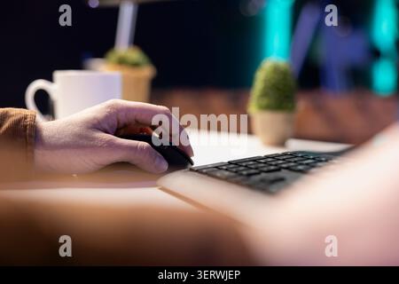 Teleworking computer technician typing on keyboard, implementing security measures to protect company systems and data. Remote IT employee at home debugging code for software, close-up. Stock Photo