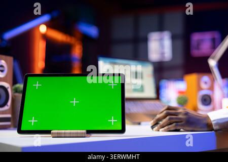 Isolated screen tablet used by worker in home office analyzing data charts, identifying trends. Freelancer using chroma key device, compiling analytical reports, processing data. Stock Photo