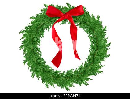 Green cedar wreath with red ribbon bow isolated cutout on white Stock Photo