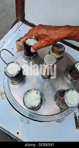 Traditional Indonesian cake made from rice flour with pandan leaves paste, pressed into a bamboo cylinder with coconut sugar filling, and then steamed Stock Photo