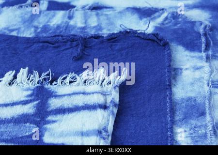 Close-up of indigo tie dyed pieces of cloth with different patterns. Concept: DIY, Do It Yourself, fabric, cotton fabric, texture, Tie-dye, textile Stock Photo