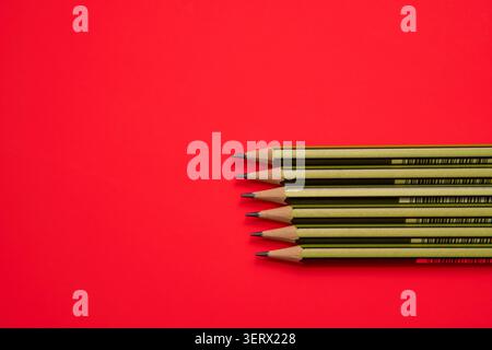 Pencils on a red background. Stock Photo