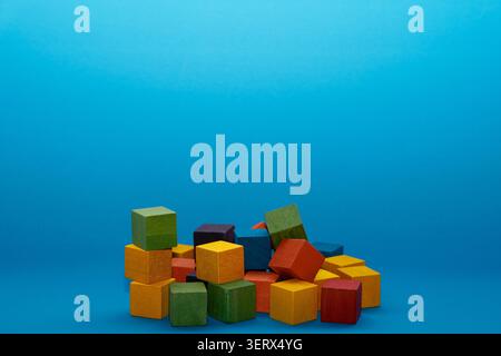 Multicolored wooden cubes on a blue background Stock Photo