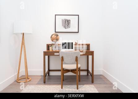Cozy study nook in a modern family home featuring a comfortable workspace, warm decor, and natural light. Stock Photo