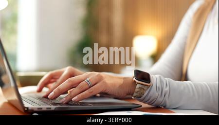 Laptop, hands and person typing, freelancer or software development with online update. Computer, remote work project and woman in home office for Stock Photo