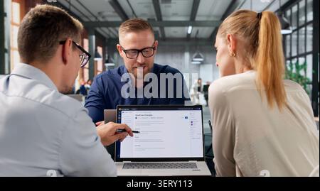 Software Engineer Leads Diverse Team Using AI-powered Knowledge Platform Tools. Stock Photo