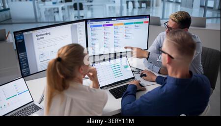 Human Resources Manager Leads Diverse Team Using Software For Recruitment Tasks Stock Photo