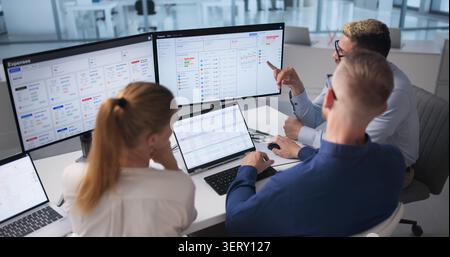 Diverse Team Works Together Using Cloud Software For Financial Forecasting. Stock Photo