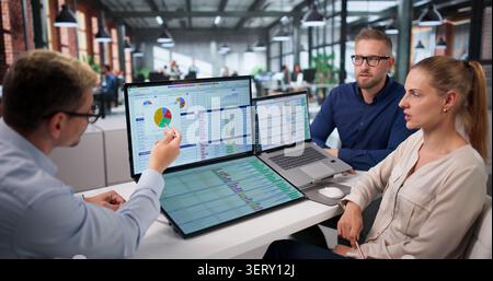 Medical Coder Team Works Together Reviewing Billing Codes On Laptops. Stock Photo