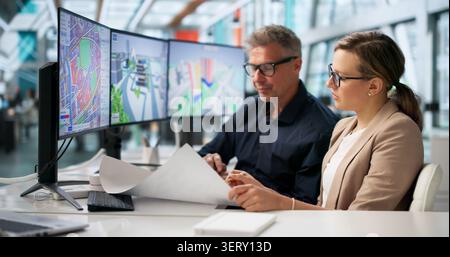 Architect And Client Discuss House Renovation Plans Using Digital Drawings Together. Stock Photo